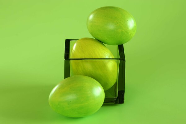 Oeufs de Pâques verts dans un cube de verre