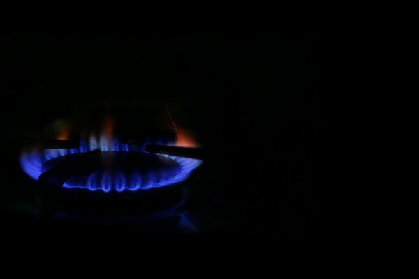 Brûleur à gaz sur fond noir. Flamme bleue et rouge