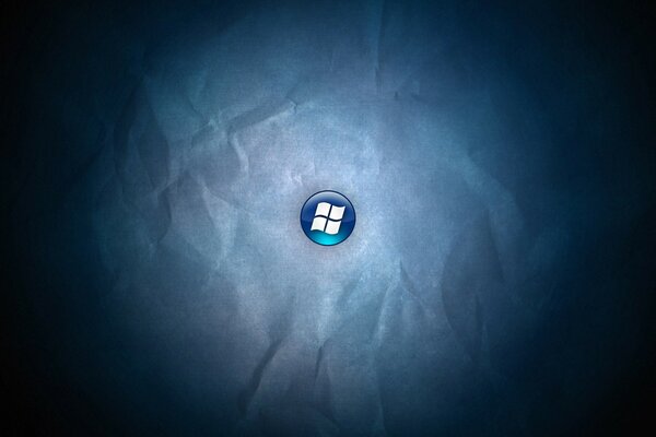 Logo windows sur un bouton bleu sur fond de papier froissé