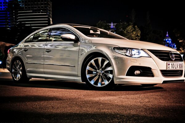 Blanc Volkswagen Passat dans la rue du soir