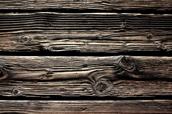 Vieux revêtement en bois dans des couleurs brun-noir