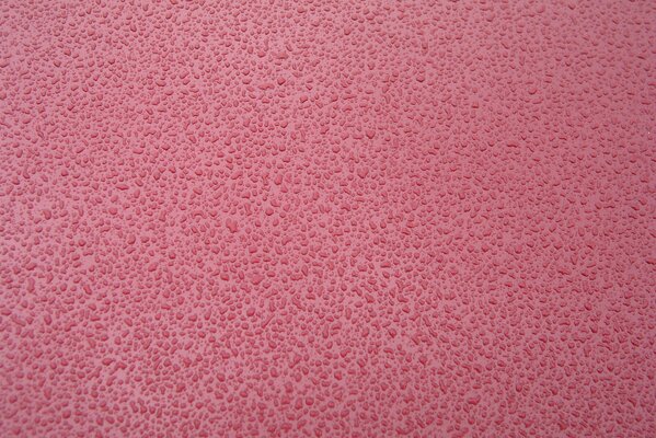 Beau fond rose texturé avec des gouttes